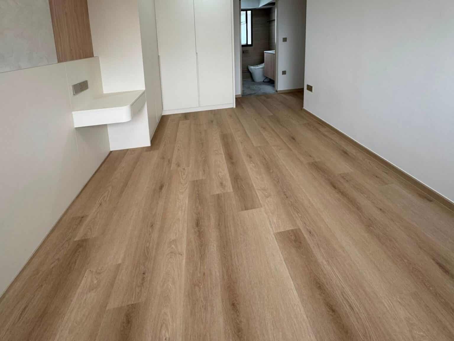 Cypress Oak vinyl flooring in a bedroom with built-in wardrobes