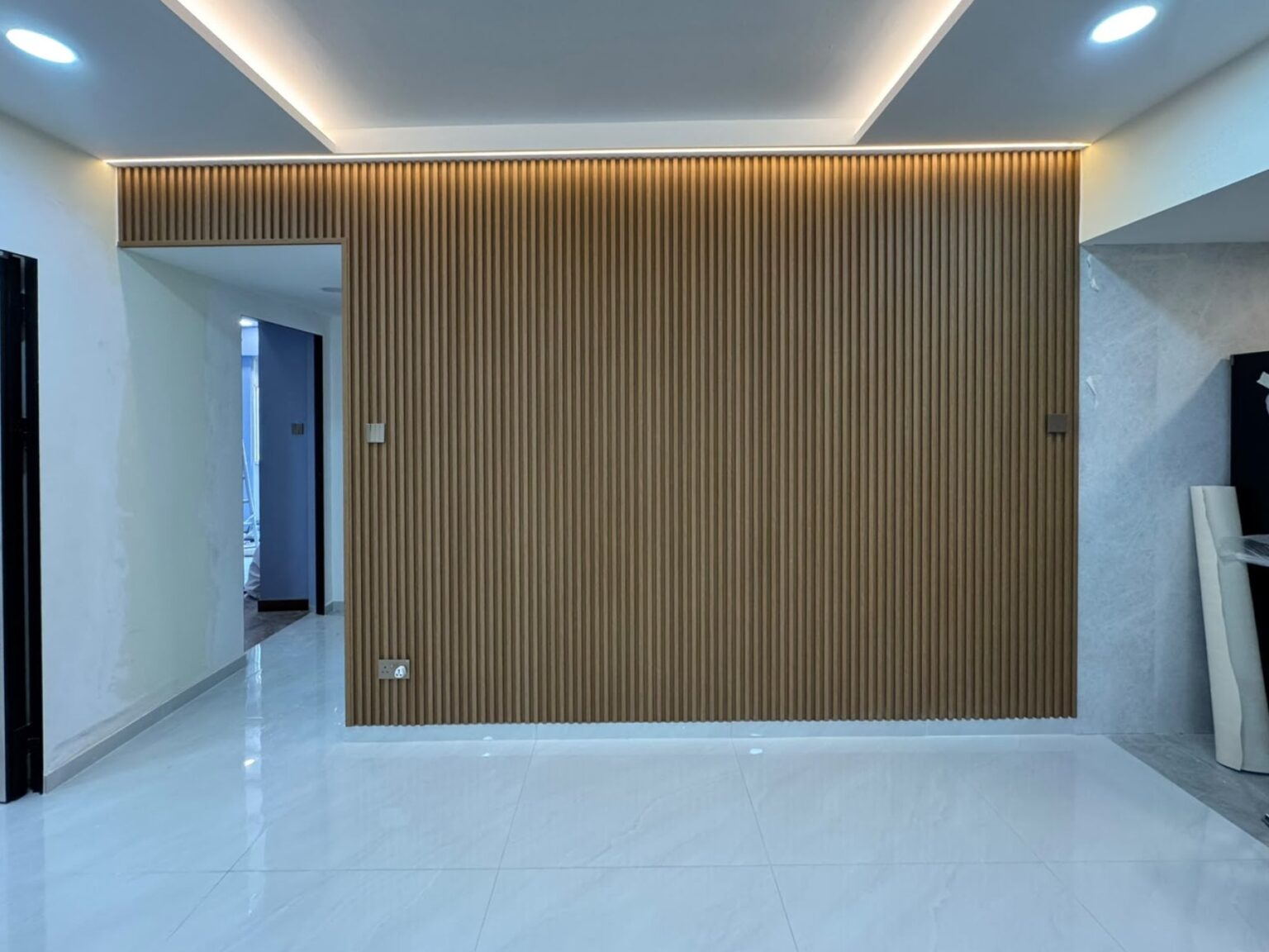 Wood fluted panel feature wall with LED cove lighting