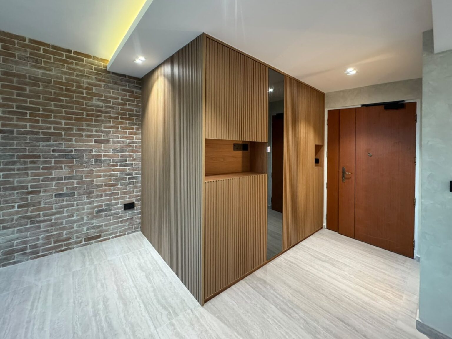 Fluted panel shoe cabinet by a brick feature wall