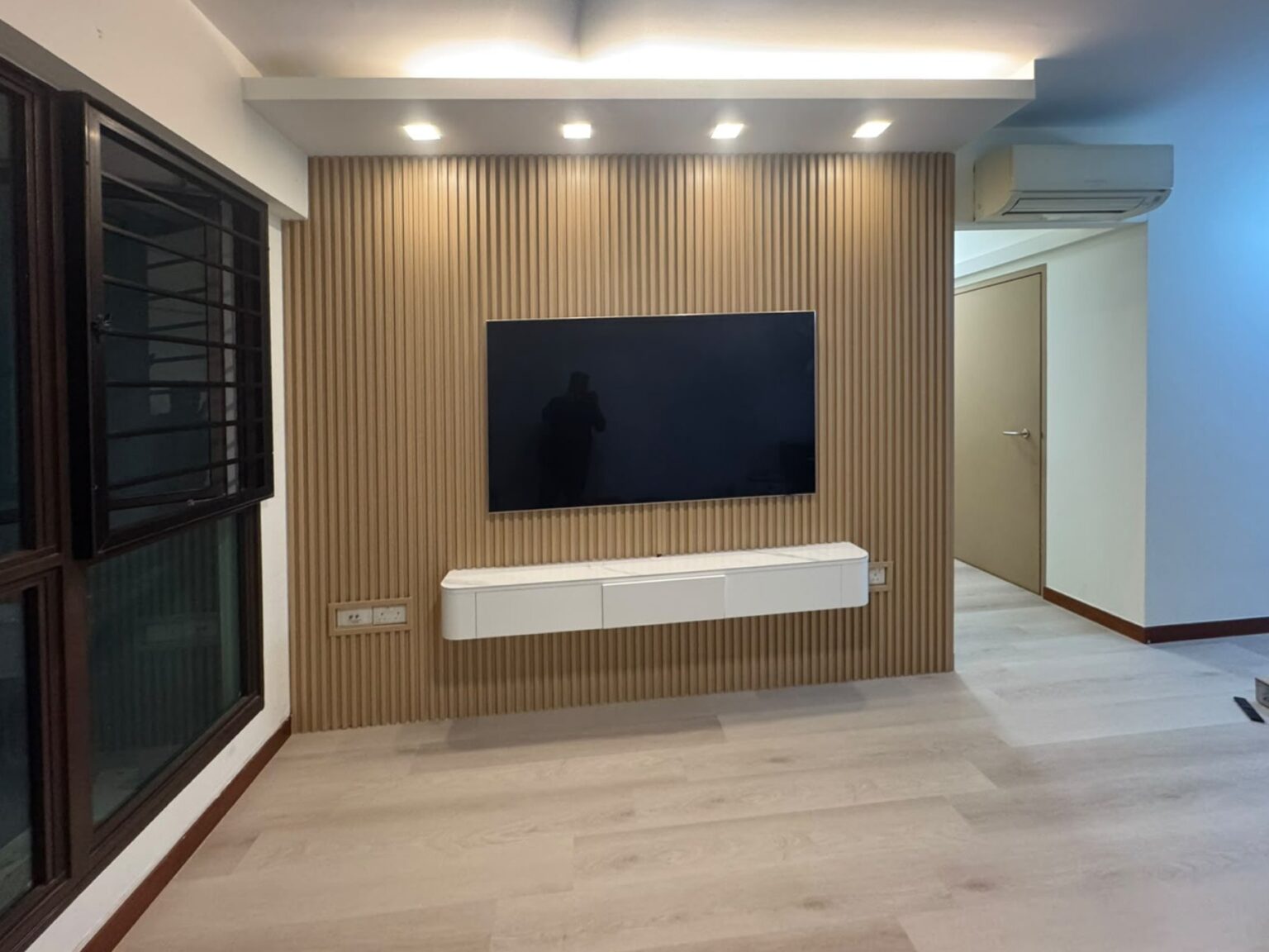 Wood fluted panel TV wall with a floating console
