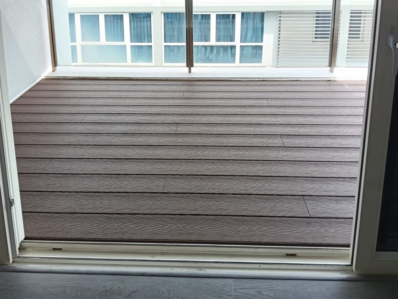 Composite decking across a balcony off the living room