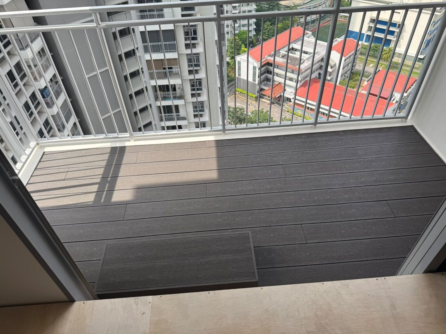 Dark composite decking on a high-floor balcony