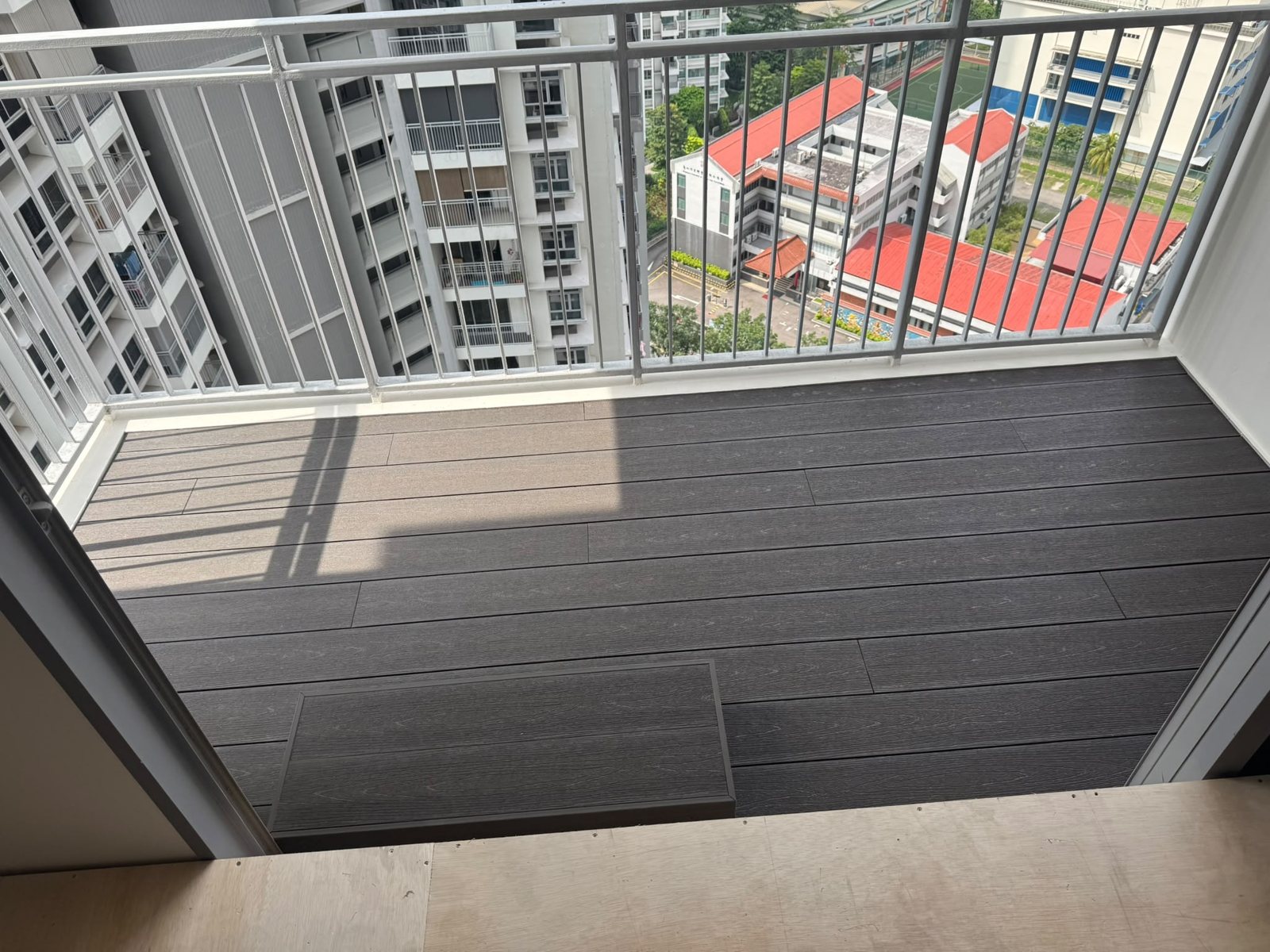 Dark composite decking on a high-floor balcony