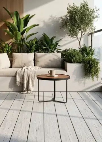 Outdoor composite decking on a balcony with a sofa and planters