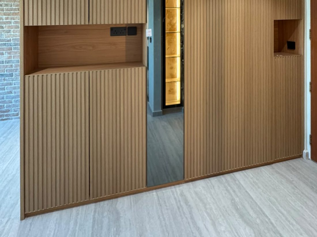 Chestnut fluted panels on a full-height shoe cabinet